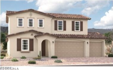 mediterranean / spanish house with driveway, an attached garage, and a tile roof