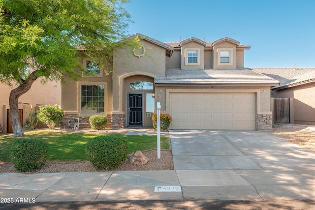 view of front of home featuring stone siding, stucco siding, concrete driveway, and a garage