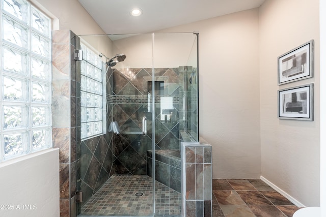 bathroom with a shower stall, stone finish flooring, and recessed lighting