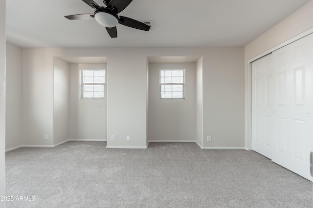 unfurnished bedroom with carpet flooring, baseboards, and a ceiling fan