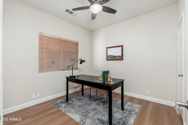 office area featuring ceiling fan, baseboards, and wood finished floors