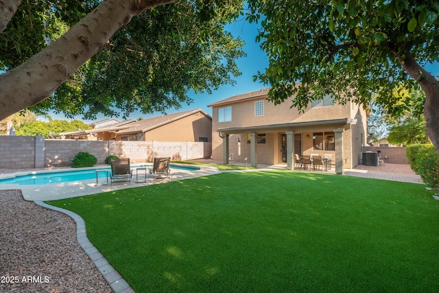 rear view of property featuring cooling unit, stucco siding, and a patio