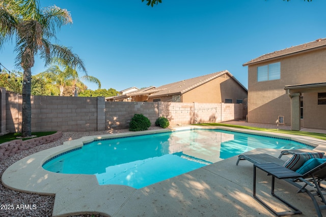view of pool with a fenced backyard and a patio