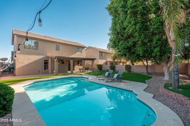 view of swimming pool with a patio area and a fenced backyard