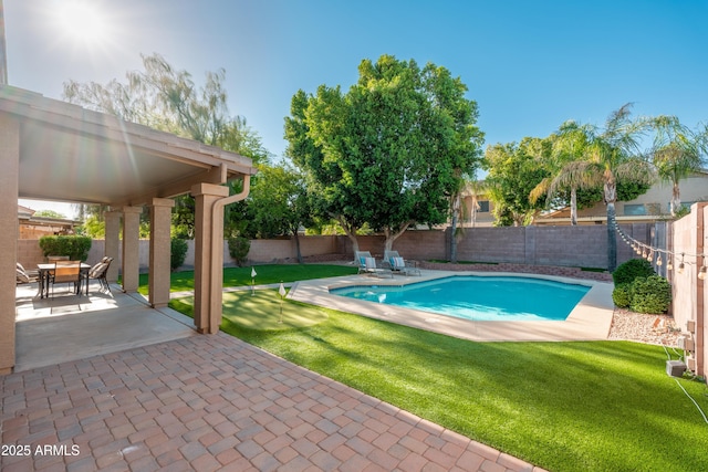 view of swimming pool featuring a patio and an area to practice putting