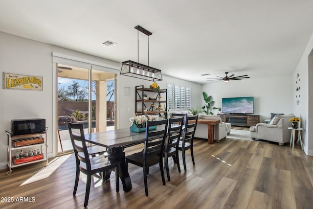 dining room featuring dark hardwood / wood-style floors and ceiling fan