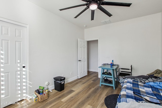 bedroom with wood-type flooring and ceiling fan