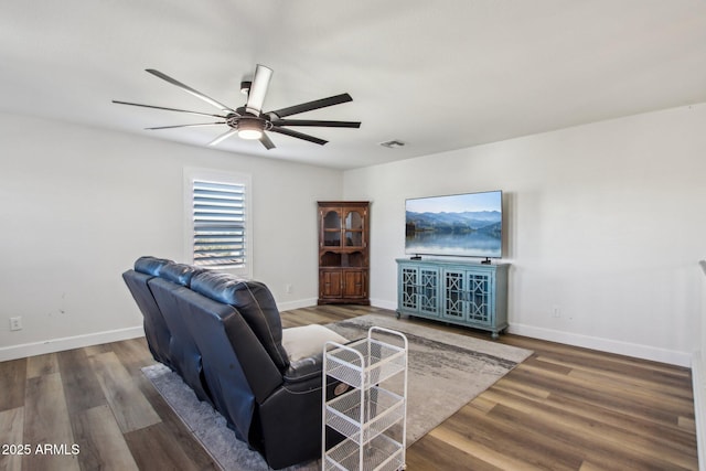 living room featuring ceiling fan and dark hardwood / wood-style floors