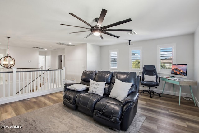 living room featuring a notable chandelier and wood-type flooring