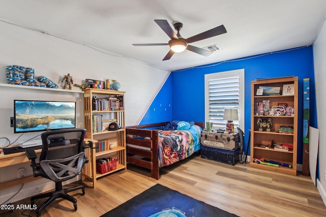 bedroom with hardwood / wood-style floors and ceiling fan