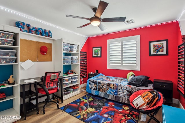 bedroom with hardwood / wood-style floors, vaulted ceiling, ornamental molding, and ceiling fan