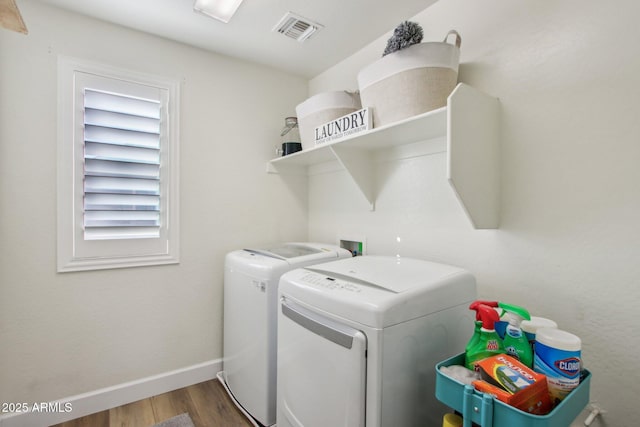 laundry room featuring dark hardwood / wood-style flooring and washer and clothes dryer