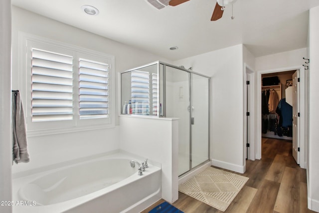 bathroom featuring independent shower and bath, hardwood / wood-style flooring, and ceiling fan