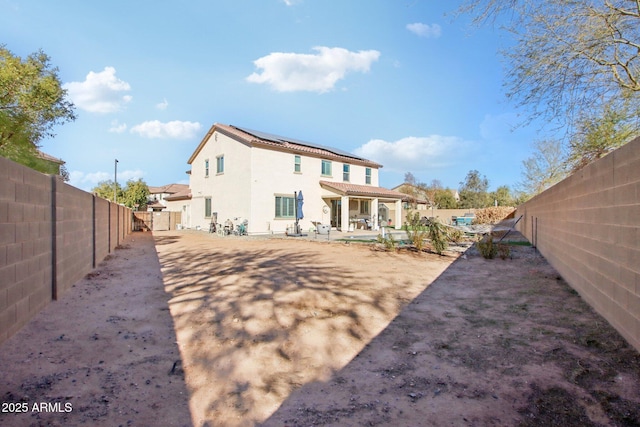 rear view of property featuring a patio area