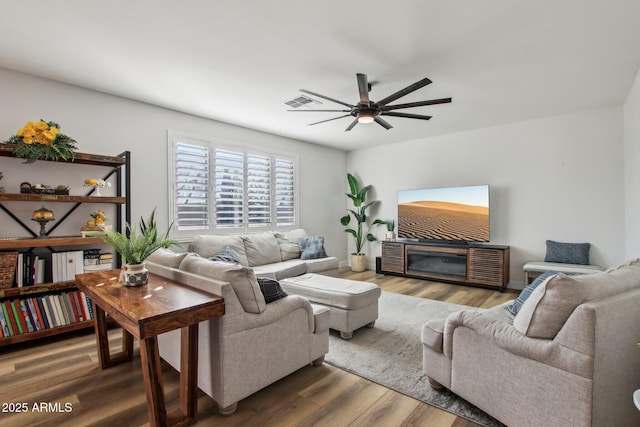 living room with ceiling fan and wood-type flooring