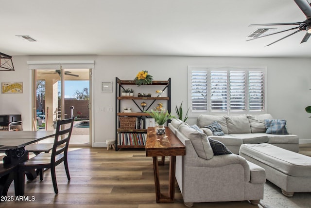 living room featuring ceiling fan and hardwood / wood-style floors