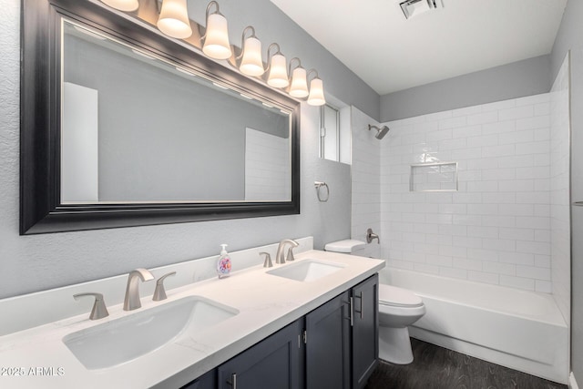 1055 E Ingram St, Mesa, AZ 85203 - bathroom with double vanity, wood finished floors, and tub / shower combination