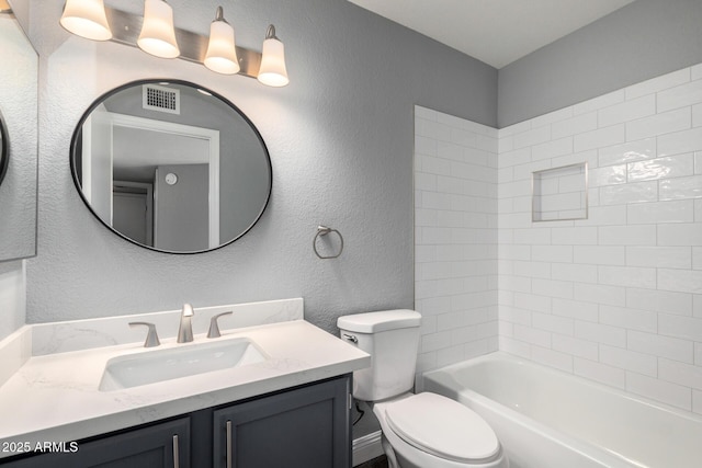 1055 E Ingram St, Mesa, AZ 85203 - bathroom featuring vanity, a textured wall, and tub / shower combination