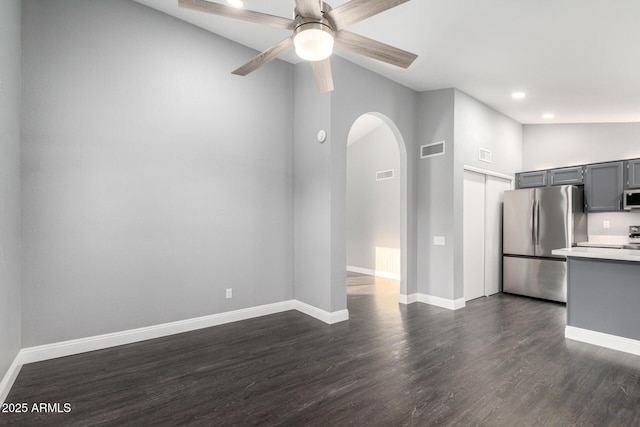 1055 E Ingram St, Mesa, AZ 85203 - unfurnished living room with arched walkways, ceiling fan, dark wood finished floors, recessed lighting, and lofted ceiling
