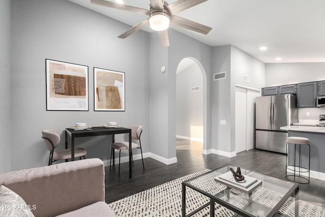 1055 E Ingram St, Mesa, AZ 85203 - living room with arched walkways, dark wood-type flooring, recessed lighting, ceiling fan, and vaulted ceiling