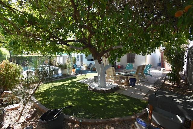 view of yard with fence and a patio