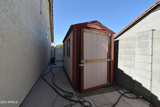 view of shed featuring fence