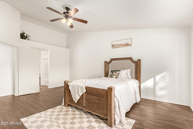 bedroom featuring hardwood / wood-style flooring, vaulted ceiling, and ceiling fan