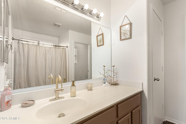 bathroom featuring vanity and curtained shower