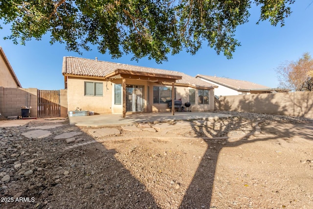 back of house with a patio area