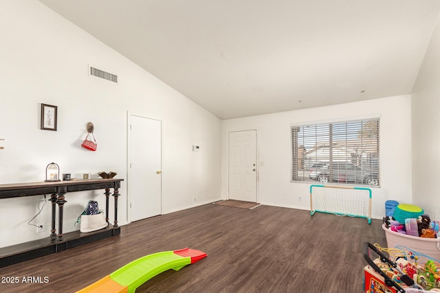 recreation room with dark hardwood / wood-style flooring and high vaulted ceiling