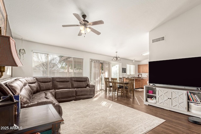 living room featuring lofted ceiling, a wealth of natural light, ceiling fan, and light hardwood / wood-style flooring