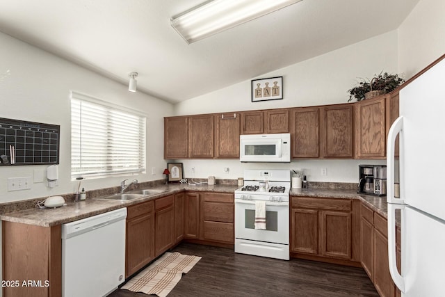 kitchen with lofted ceiling, sink, white appliances, and dark wood-type flooring