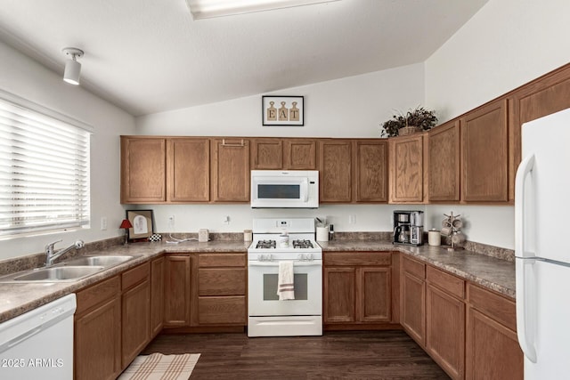 kitchen with dark hardwood / wood-style floors, lofted ceiling, sink, and white appliances