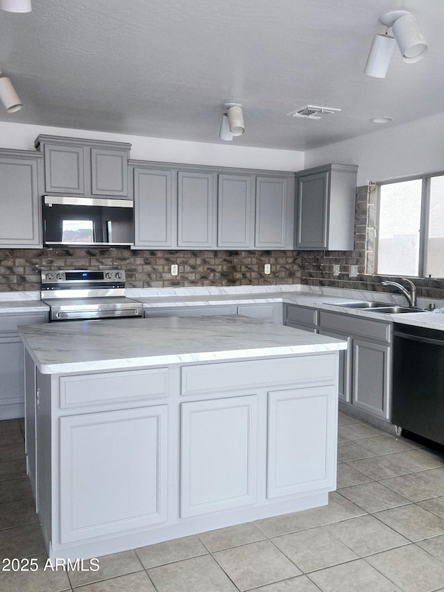 kitchen featuring a sink, gray cabinets, and stainless steel appliances