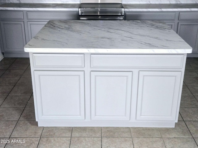 room details with light stone counters and gray cabinetry