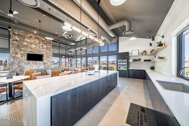 interior space with a high ceiling, tile patterned floors, and a sink