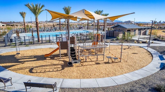 community playground with a community pool and fence