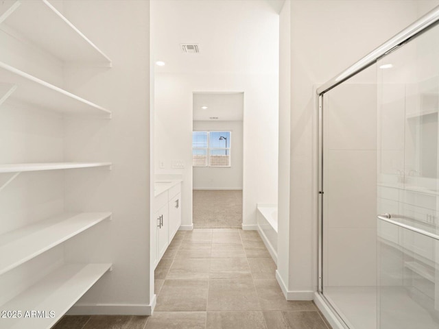 full bathroom with a garden tub, visible vents, a stall shower, and vanity
