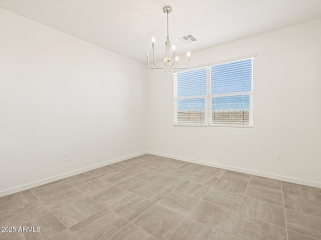unfurnished room featuring baseboards, visible vents, and an inviting chandelier