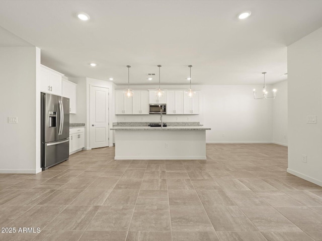 kitchen with white cabinetry, recessed lighting, a chandelier, a kitchen island with sink, and appliances with stainless steel finishes