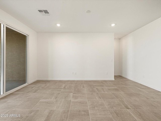 unfurnished room with baseboards, visible vents, and recessed lighting