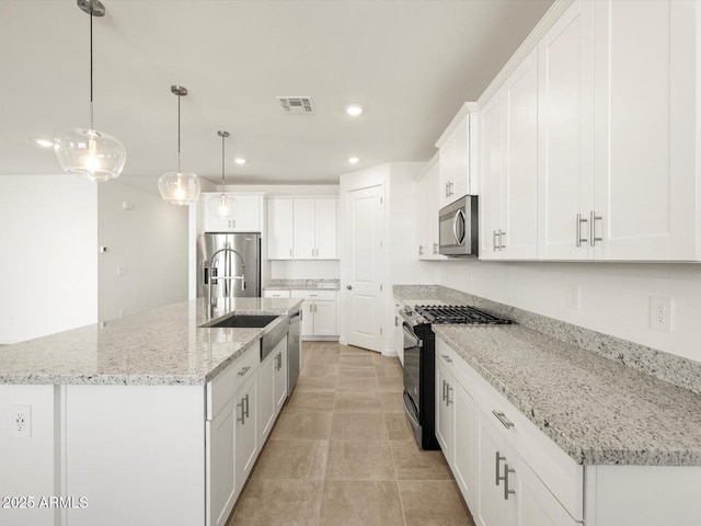 kitchen featuring recessed lighting, visible vents, white cabinets, a kitchen island with sink, and appliances with stainless steel finishes