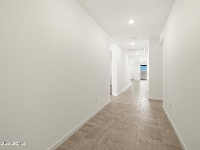 corridor with baseboards, visible vents, and recessed lighting