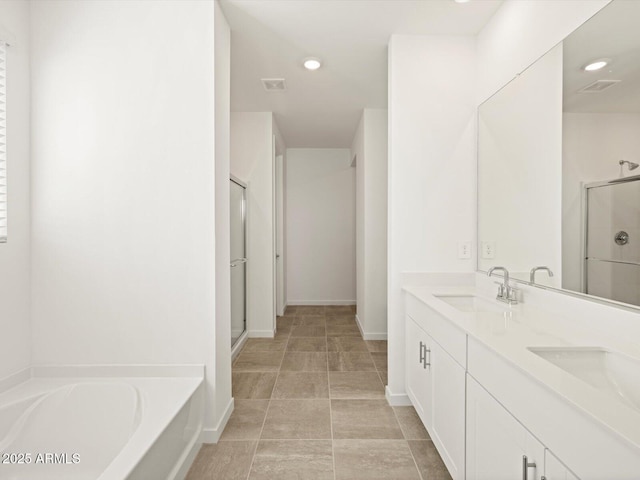 full bath featuring a sink, a bath, a stall shower, and visible vents