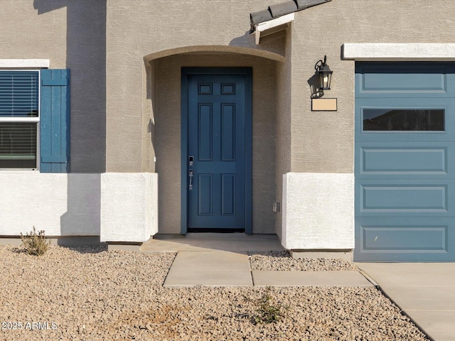 property entrance featuring stucco siding