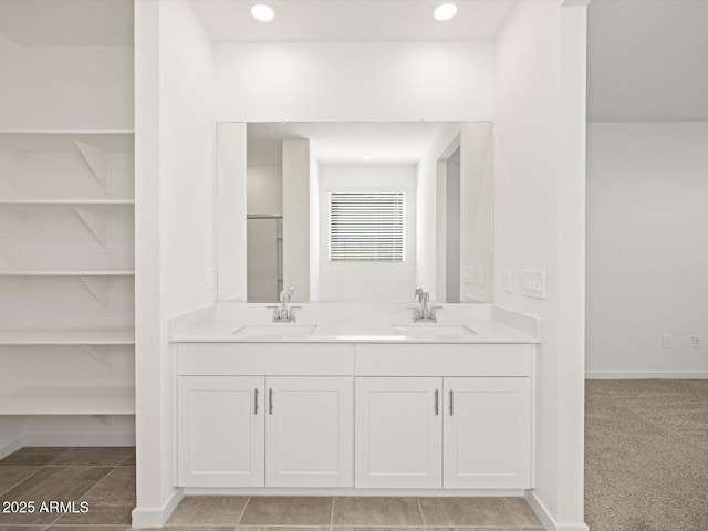 bathroom with double vanity, a sink, and recessed lighting