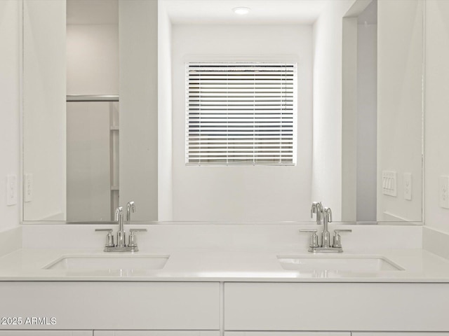 full bathroom with double vanity and a sink