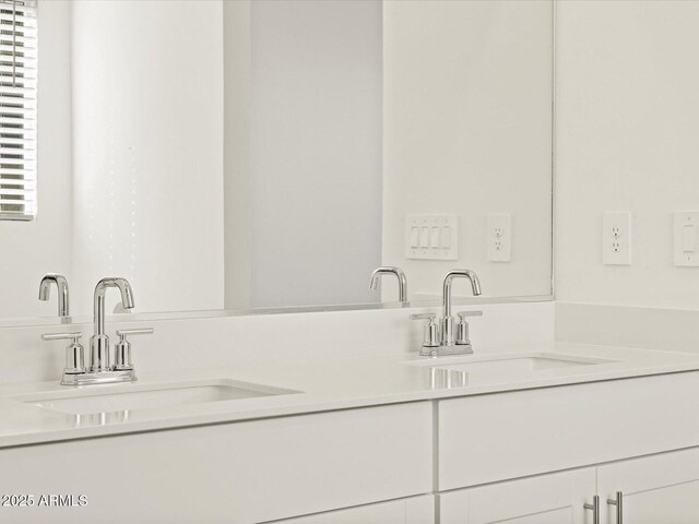 bathroom featuring double vanity and a sink