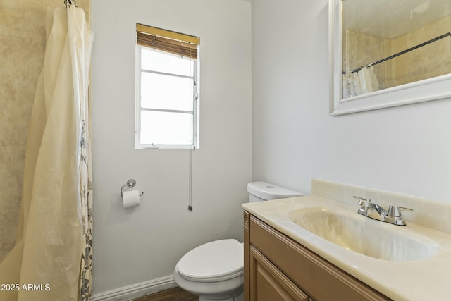 bathroom featuring toilet and vanity