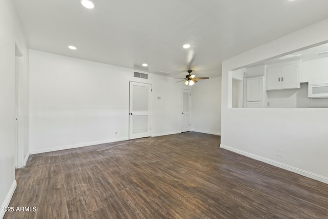 empty room featuring ceiling fan and dark hardwood / wood-style floors